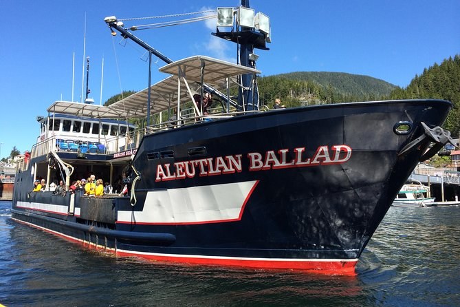 The crab boat Aleutian Ballad tied up at the dock, forested hills behind