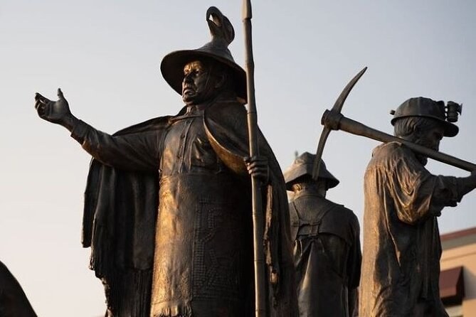 Bronze figures of a woman in a woven hat and a miner shouldering a pickaxe