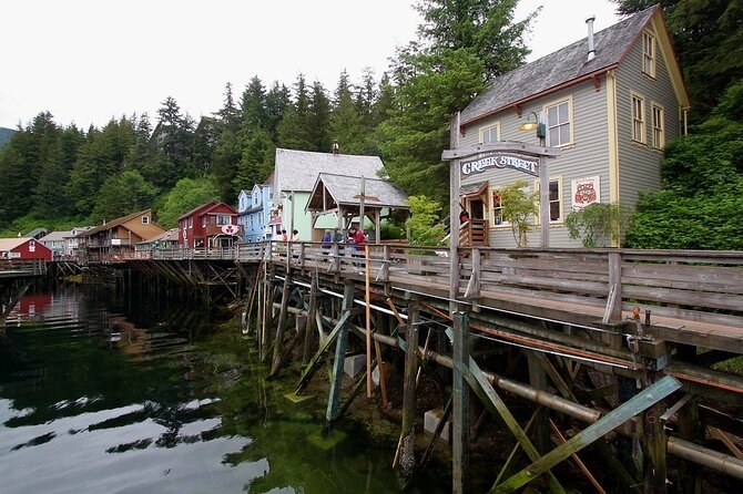 Creek Street's wooden boardwalk and houses standing on pilings over the creek